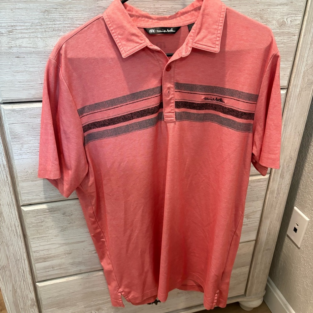 Travis Mathew Coral Polo with Black Stripe Detail